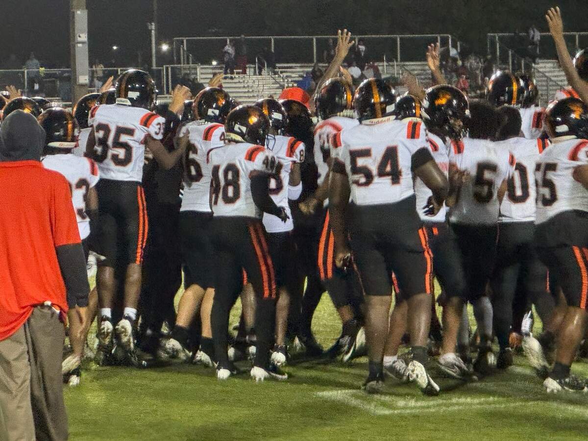Booker T. Washington’s players celebrate following a 27-14 victory over Miami Southridge on Friday night at Southridge Park.