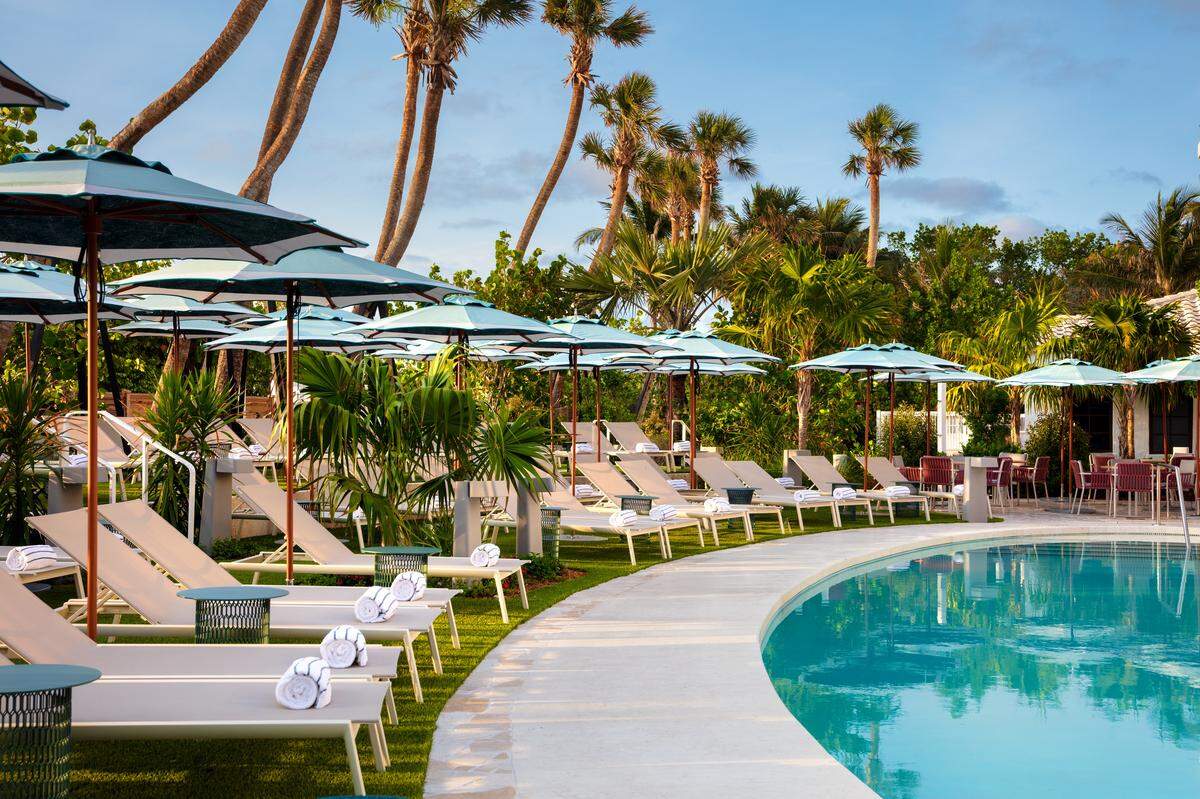 Resort-style lounging under striped umbrellas at the Andaz’s lush pool deck.