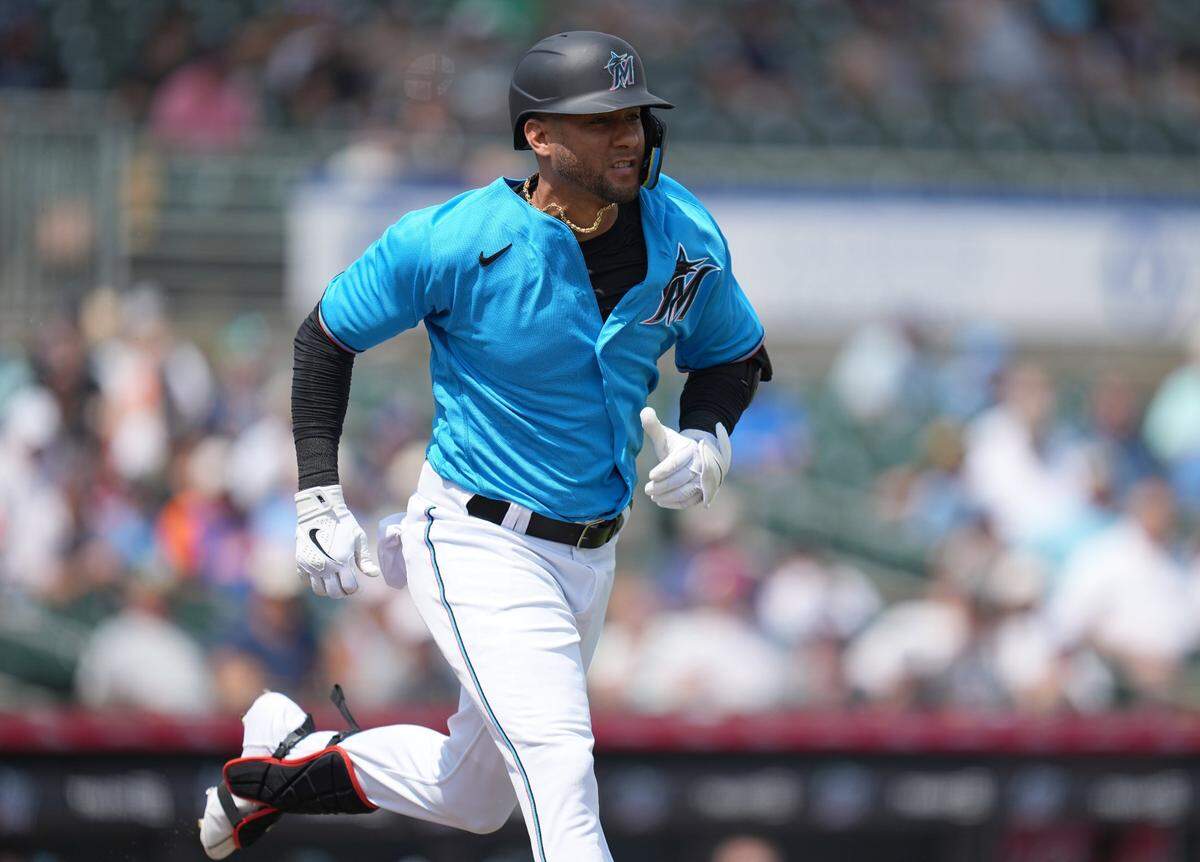 Miami Marlins designated hitter Yuli Gurriel (97) runs out a ground ball to first base in the second inning against the New York Mets at Roger Dean Stadium in Jupiter, Florida, on Monday, March 13, 2023.