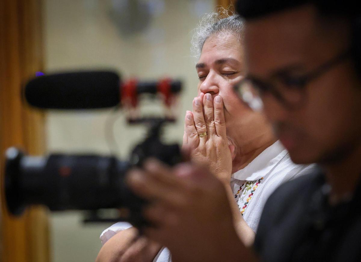 Olga Lucia Villar, center, executive director of Southeast Pastoral Institute, prays as Archbishop Thomas Wenski offered the first of the traditional nine Masses offered for the repose of the soul of Pope Francis at the Church of St. Martha on April 21, 2025, in Miami Shores, Florida.&nbsp;&nbsp;