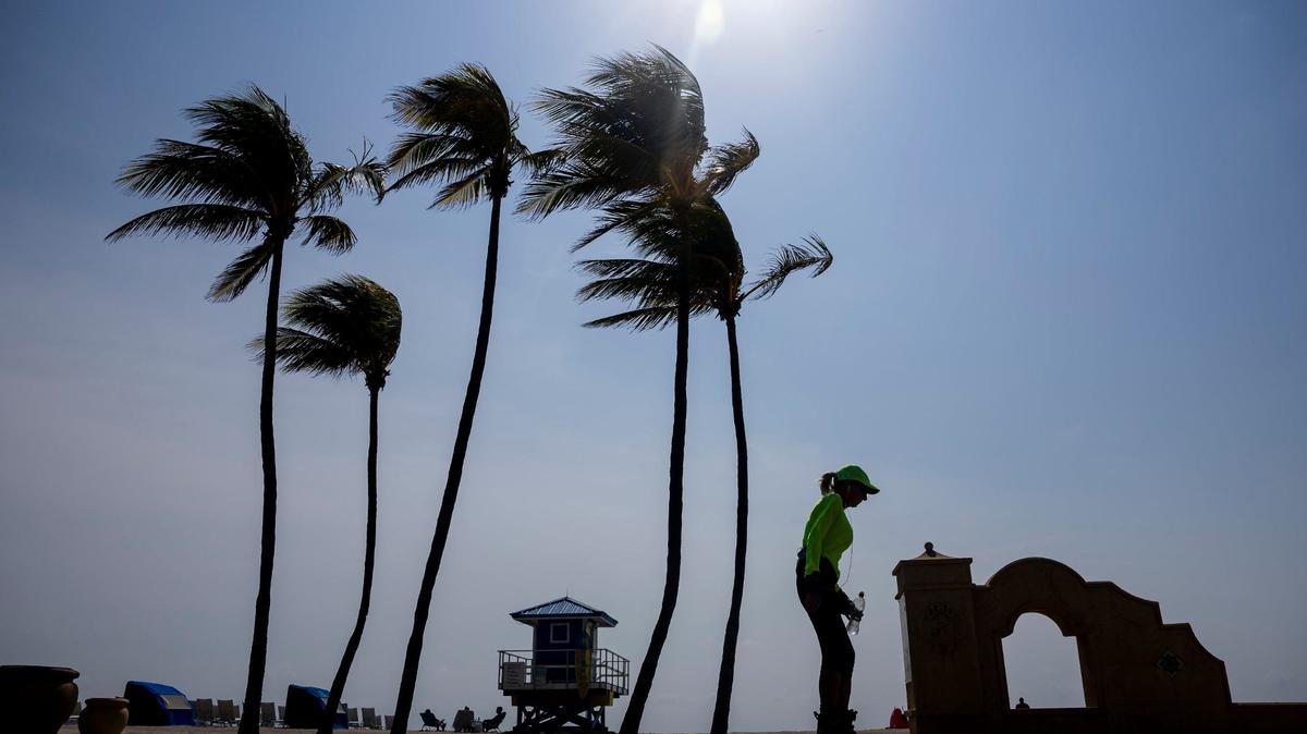A woman makes her way down Hollywood Beach Broadwalk as temperatures soar into the 90s on Tuesday, May 14, 2024, in Hollywood, Fla.