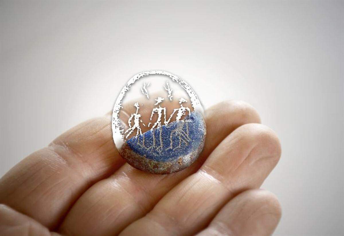 A reconstruction shows what the amulet might have looked like before it broke.