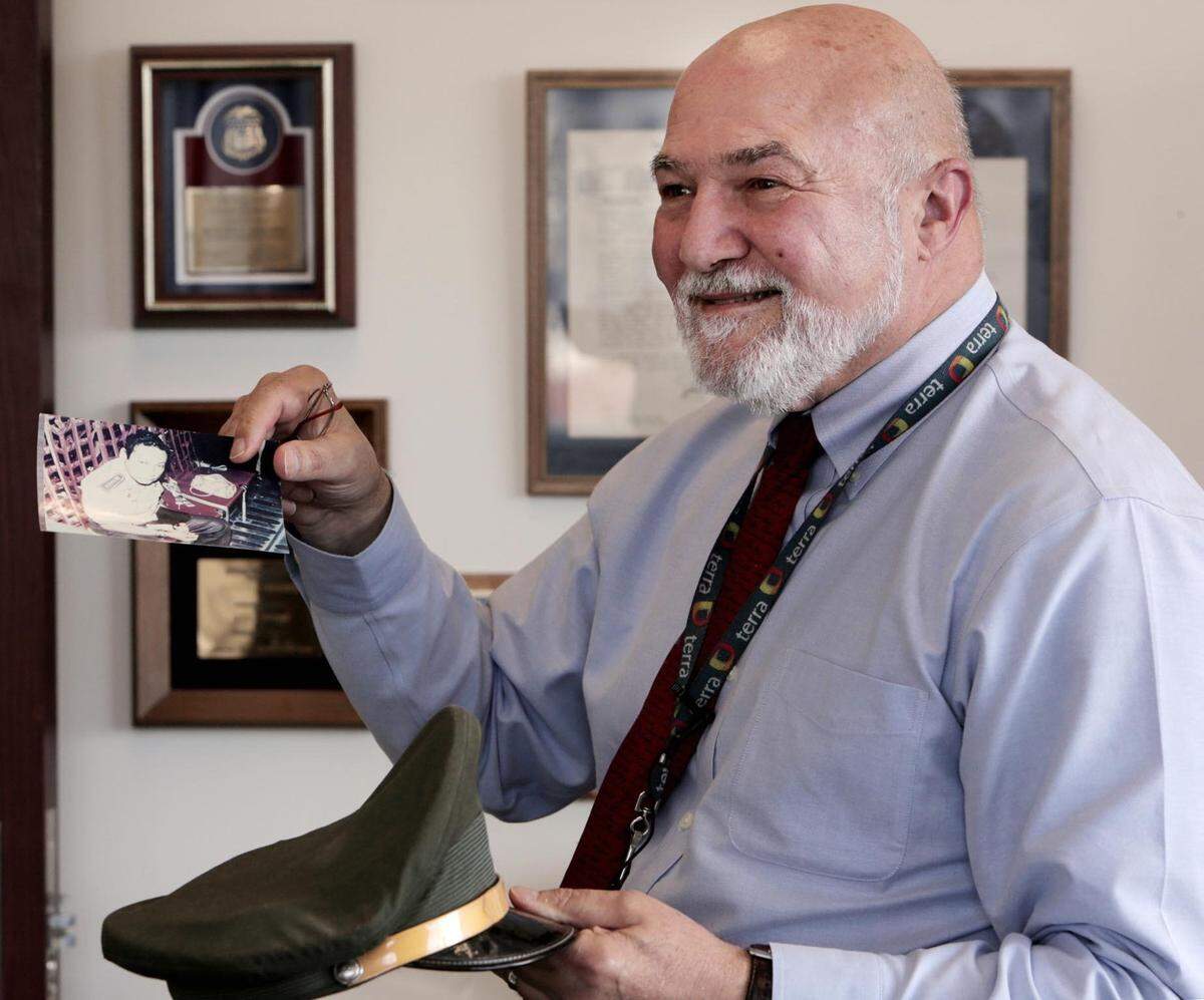 Federal prosecutor Dick Gregorie holds a picture of Gen. Manuel Noriega and Noriega’s hat at the Miami U.S. Attorney’s Office.