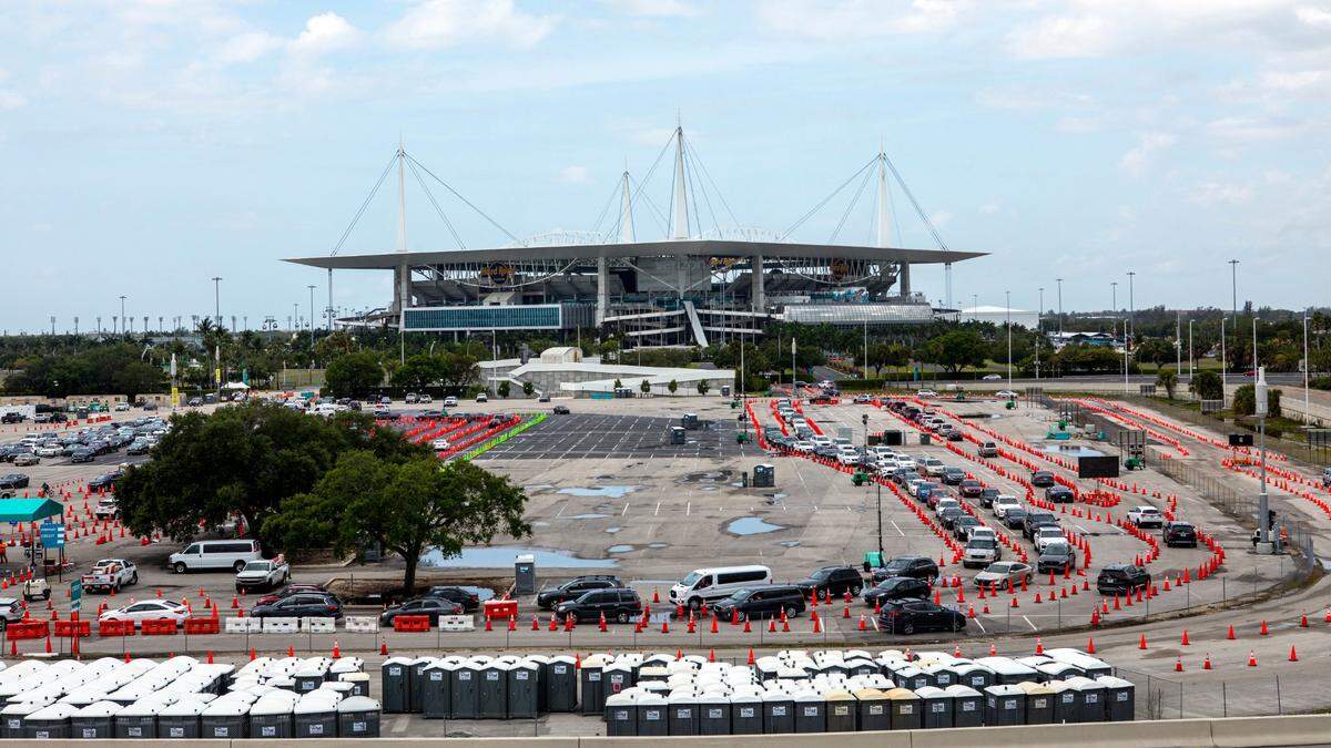 People line up inside their cars to get vaccinated at Hard Rock Stadium in Miami Gardens, Florida, on Monday, April 12, 2021. The site will no longer require appointments and have expanded COVID vaccine hours.