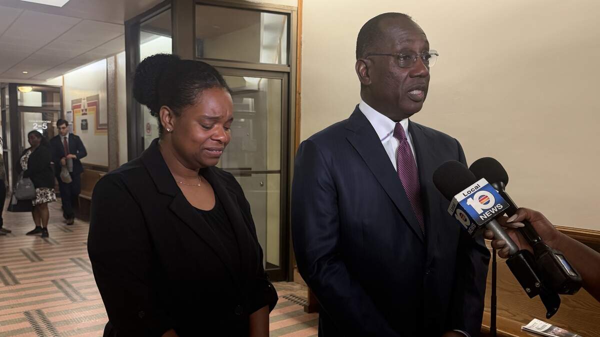 Attorney Larry Handfield speaks to reporters as his client, Precious Bland, stands next to him outside a Miami courtroom on Tuesday, June 23, 2026. Bland, who drowned her daughter in a bathtub, was found not guilty by reason of insanity.