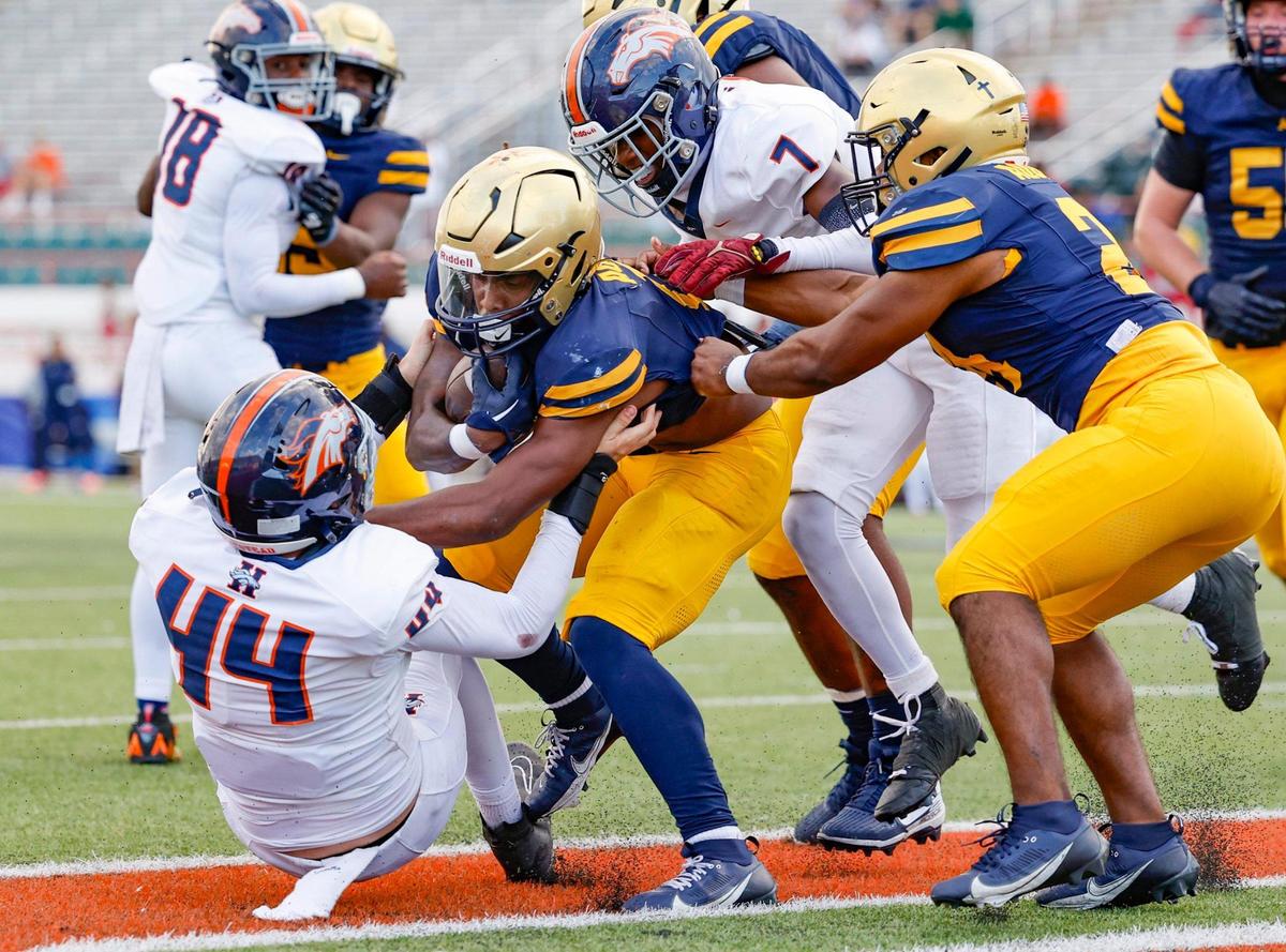 St. Thomas Aquinas running back Jordan Lyle (1) scores as Homestead Broncos Johannes Mager (44) fails to make the stop in the first half of the Class 3M state championships at Bragg Memorial Stadium in Tallahassee, Florida, on Saturday, December 9, 2023.