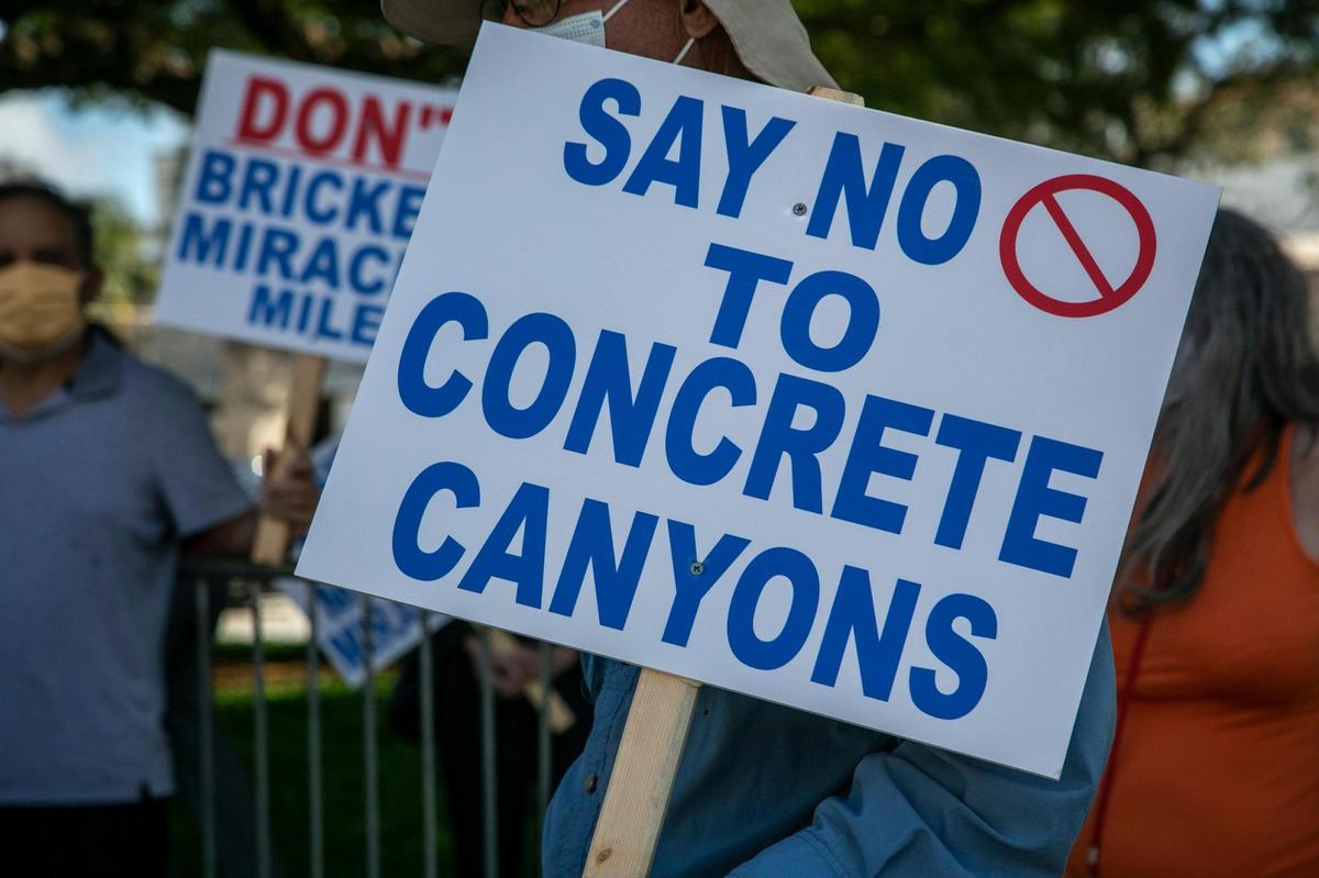 Protesters carry signs in front of Coral Gables City Hall during a Feb. 9 demonstration over proposed zoning changes that would promote redevelopment on Miracle Mile.