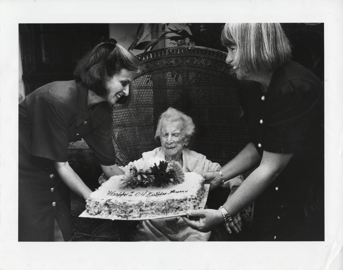 Marjory Stoneman Douglas getting a birthday cake from her friends, left, Sharon Richardson (Friends of the Everglades) and, right, Theodora Long of Marjory Stoneman Douglas Biscayne Nature Center on her 104th birthday. She died in 1998 at age 108. 