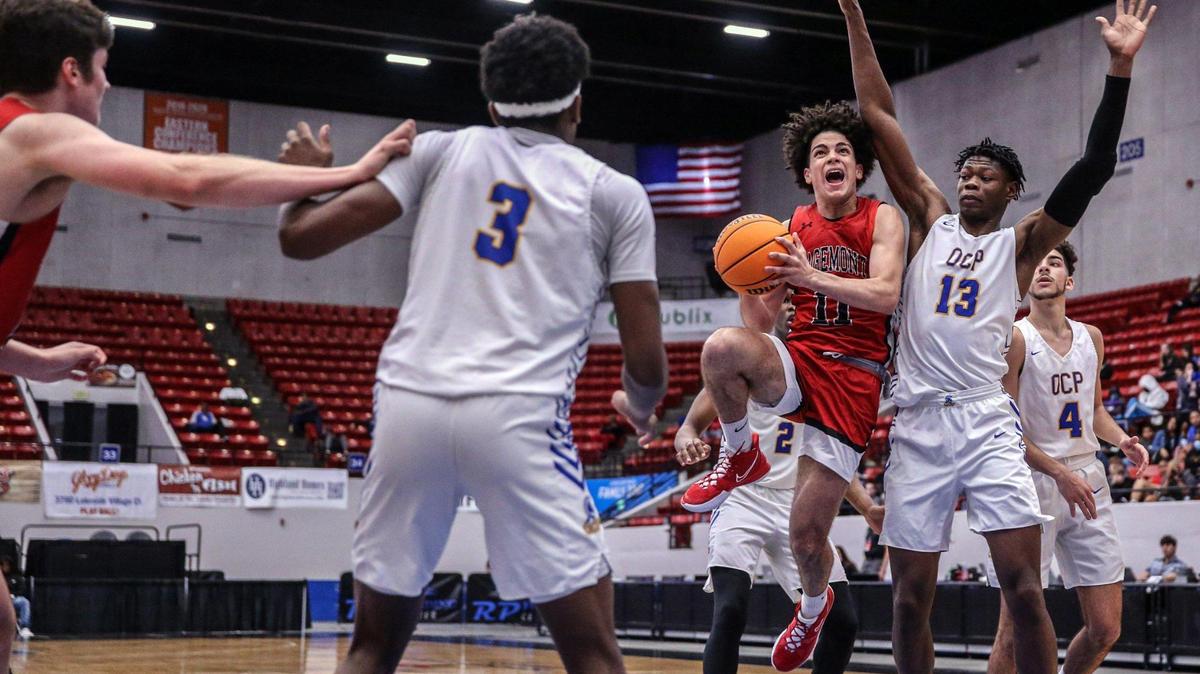 Sagemont guard Adrian Cruz (11) drives to the basket as Christian Prep orward Jayden Hastings (13) defends in the Florida High School Athletic Association Class 2A boys basketball state championship at the RP Funding Center in Lakeland on Saturday, March 5, 2022.