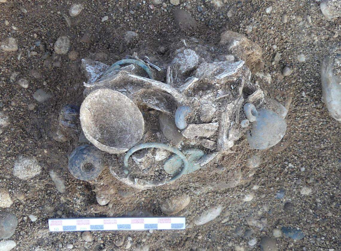 A young child buried alongside bracelets and shell pendants.