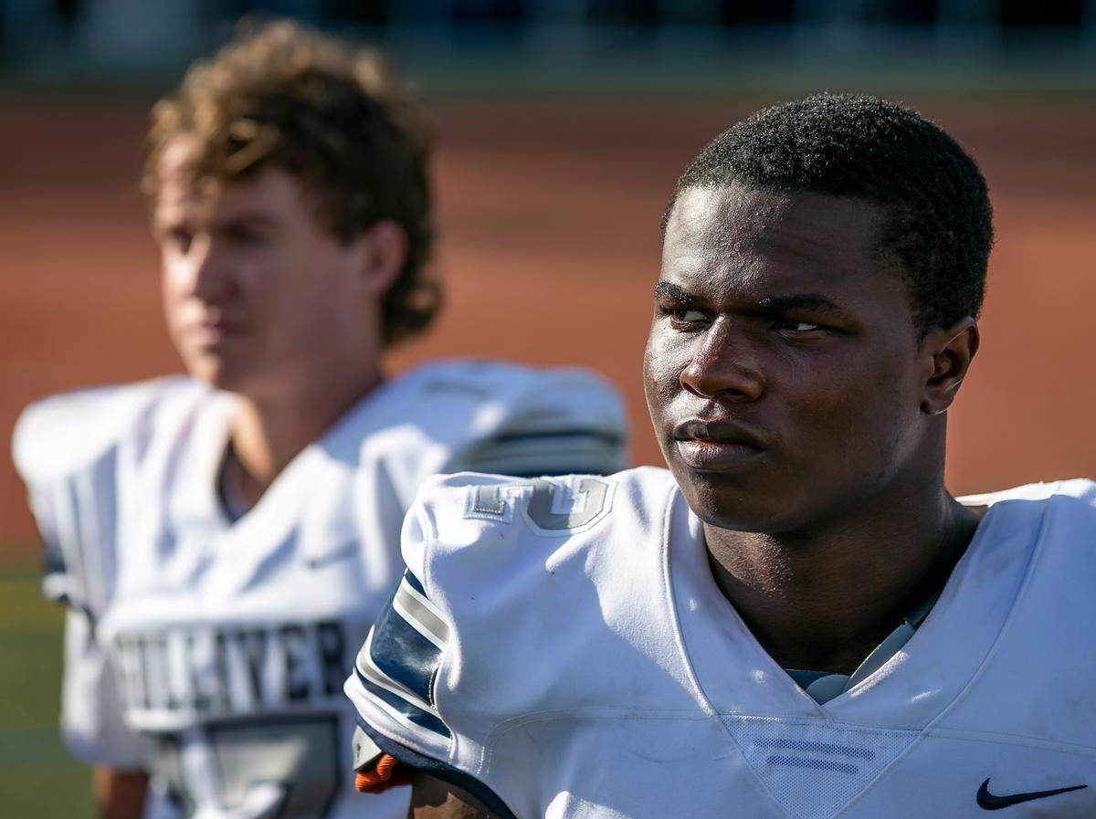 Gulliver Prep athlete Travious Lathan listens to his coach during a preseason practice at their school’s football field in Pinecrest, Florida on Monday, August 9, 2021.