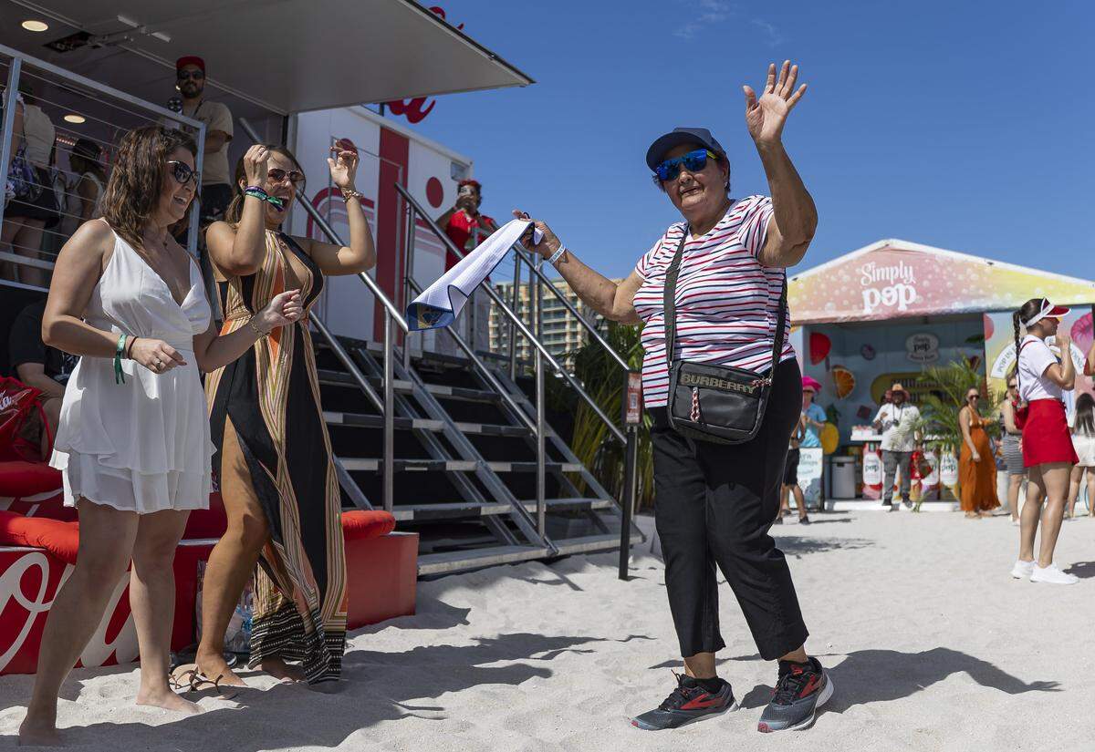 Miriam Rosales, 80, dances at the Coca-Cola booth inside the Goya Foods' Grand Tasting Village during the Food Network South Beach Wine & Food Festival on Saturday, Feb. 21, 2026, in Miami Beach, Fla.