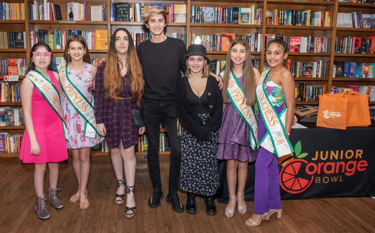 Celebrating at the March 8 Junior Orange Bowl Creative Writing Contest awards ceremony at Books & Books are, from left, Junior Orange Bowl Sweetheart Caroline, Princess Aubrey, Brianna Roque, Chance Ammirata, Alex Schefter, Princess Adriana, and Duchess Lynette.