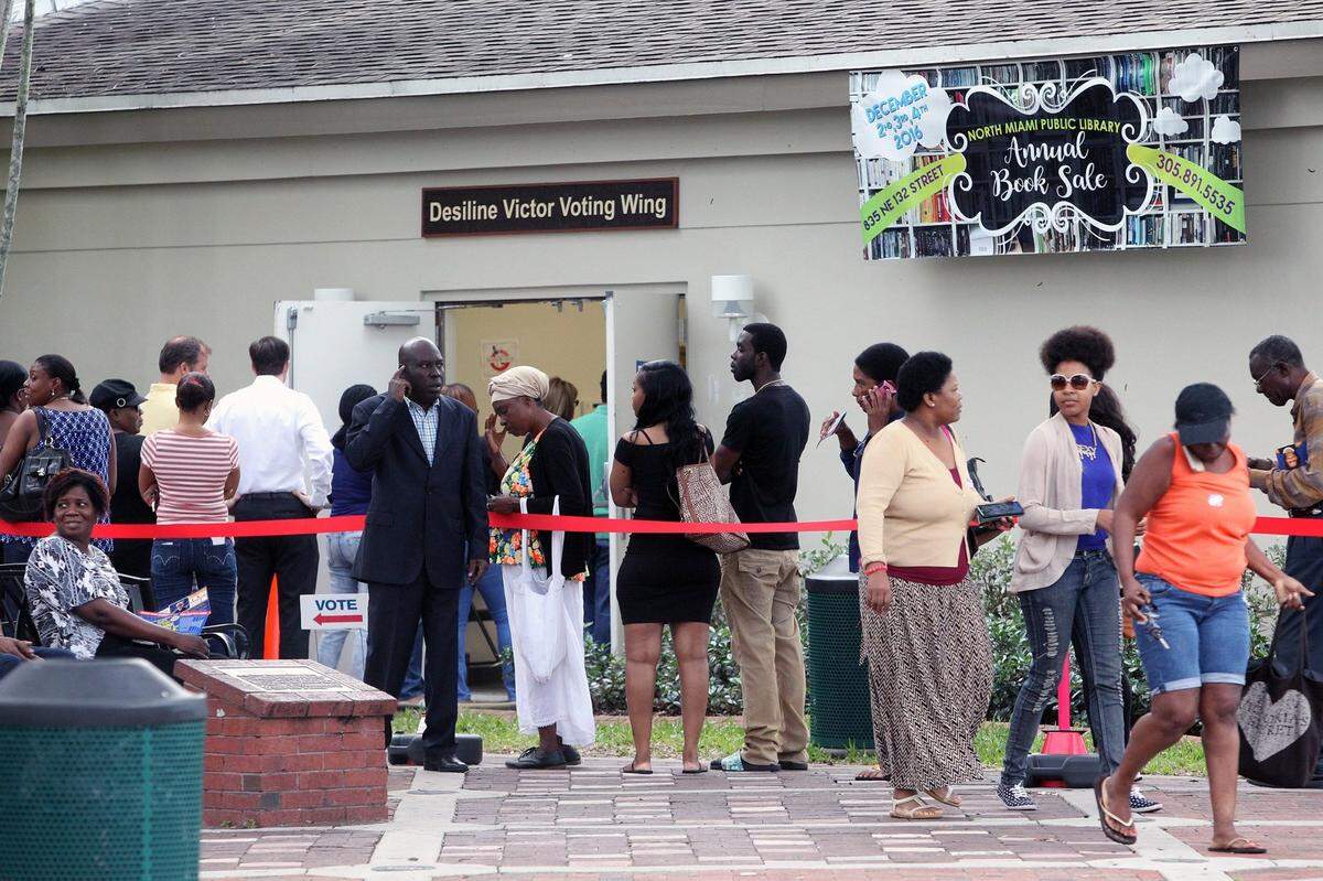 People stand in line outside North Miami Public Library during early voting on Nov. 4, 2016.