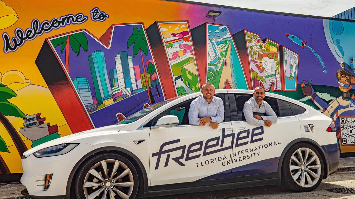 Freebee ride-hailing service co-founders Kristopher Kimball, left, and Jason Spiegel are shown in a Freebee electric car in Miami on Oct. 17, 2022.