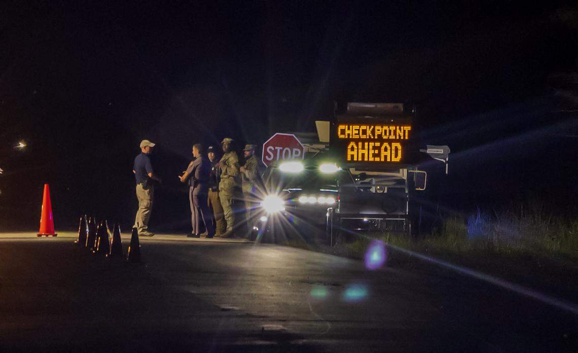 Law enforcement officers and Florida National Guard soldiers gathered at the check point to the migrant detention center, “Alligator Alcatraz,” located at the site of the Dade-Collier Training and Transition Airport in Ochopee, Florida on Wednesday July 02, 2025.