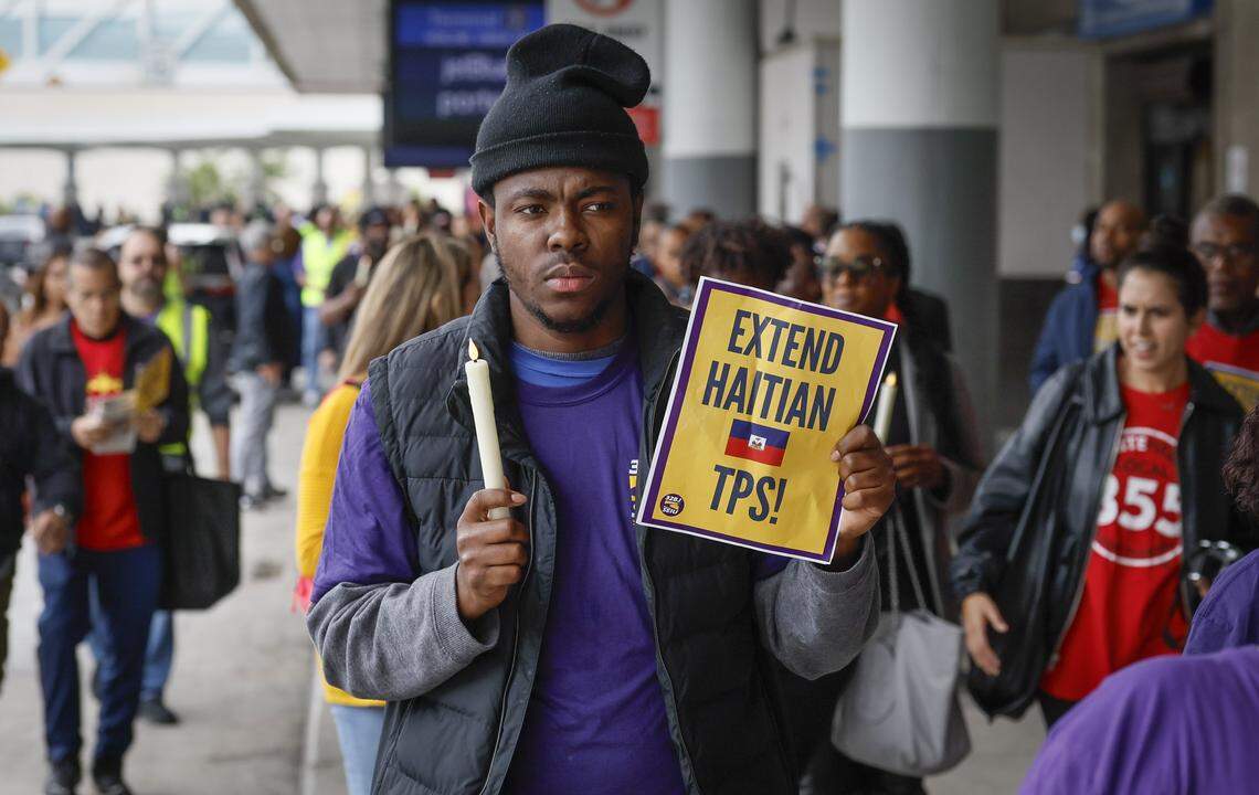 Yronel Cabrera walks with protesters during a candlelight vigil and interfaith prayer at Fort Lauderdale–Hollywood International Airport Jan. 28, 2026, as airport workers and faith leaders rally calling on the Trump Administration to extend Temporary Protected Status for Haitians.
