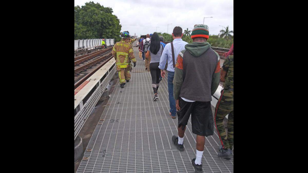 This photo from a Metrorail passenger shows the evacuation from a derailed train on Friday, July 12, 2019. County firefighters led passengers on a walkway off the tracks to the Earlington Heights station.