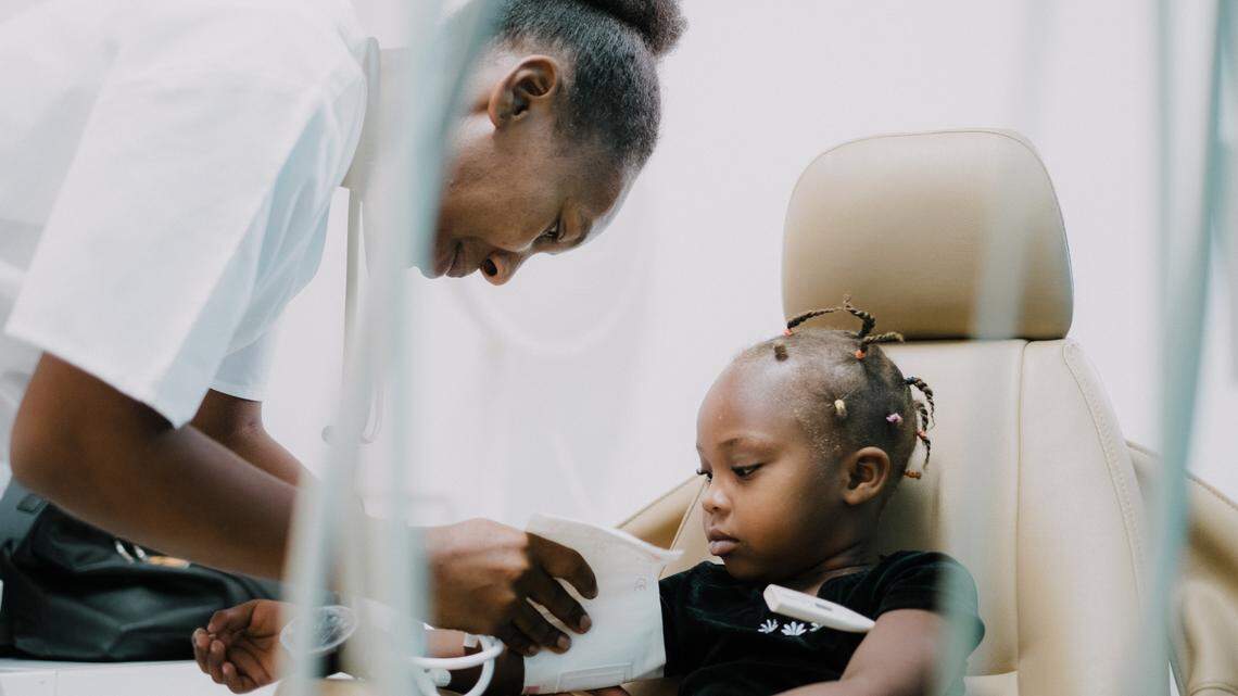 A healthcare worker at Hope for Haiti tends to a young patient. The charity recently received a $3 million gift from Bob Parsons, co-founder of GoDaddy, and his wife Renee.