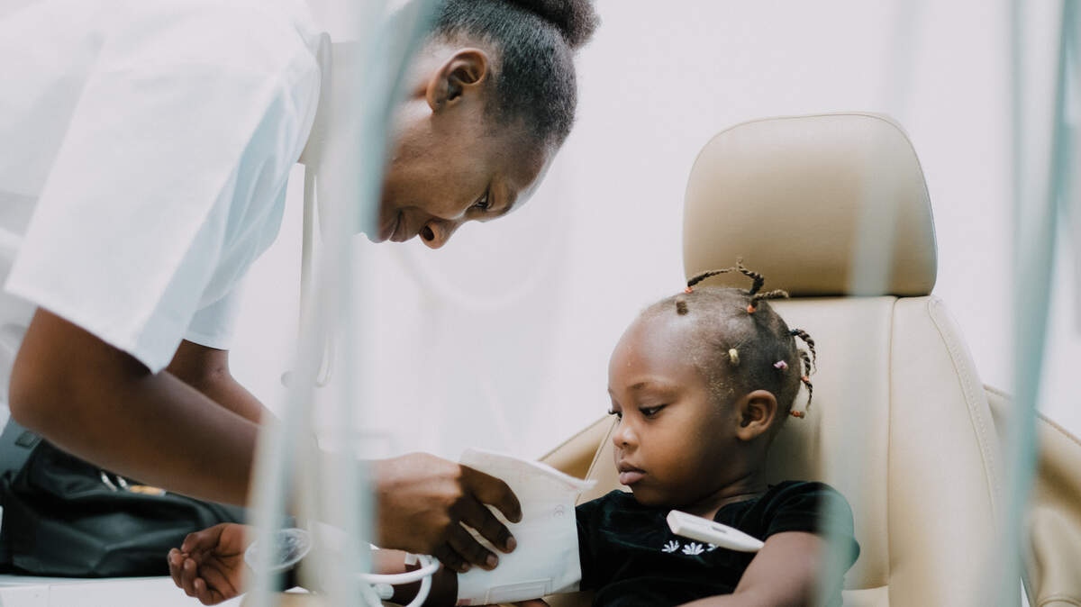 A healthcare worker at Hope for Haiti tends to a young patient. The charity recently received a $3 million gift from Bob Parsons, co-founder of GoDaddy, and his wife Renee.