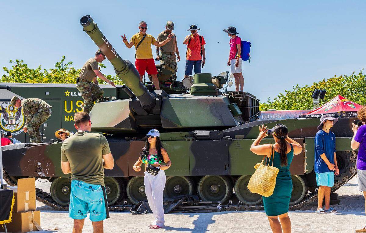 Attendees check and posed on top of a Abrams tank on display at the Army village in South Beach as the Hyundai Air & Sea Show returns for its eighth annual National Salute to America’s Heroes in Miami Beach, on Saturday, May 25, 2024