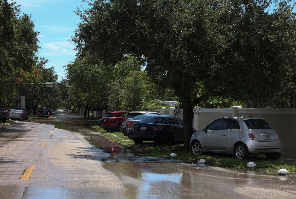 Cars that cannot make it through the flooding on Southwest 196th Street park on the side of the road on Tuesday, June 7, 2022, in Cutler Bay following the weekend storms.
