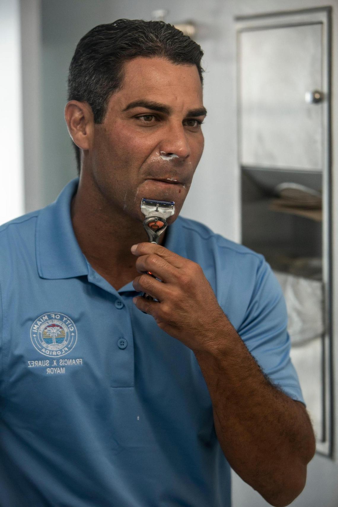 Miami Mayor Francis shaves in his office in preparation for a press conference at Miami City Hall.