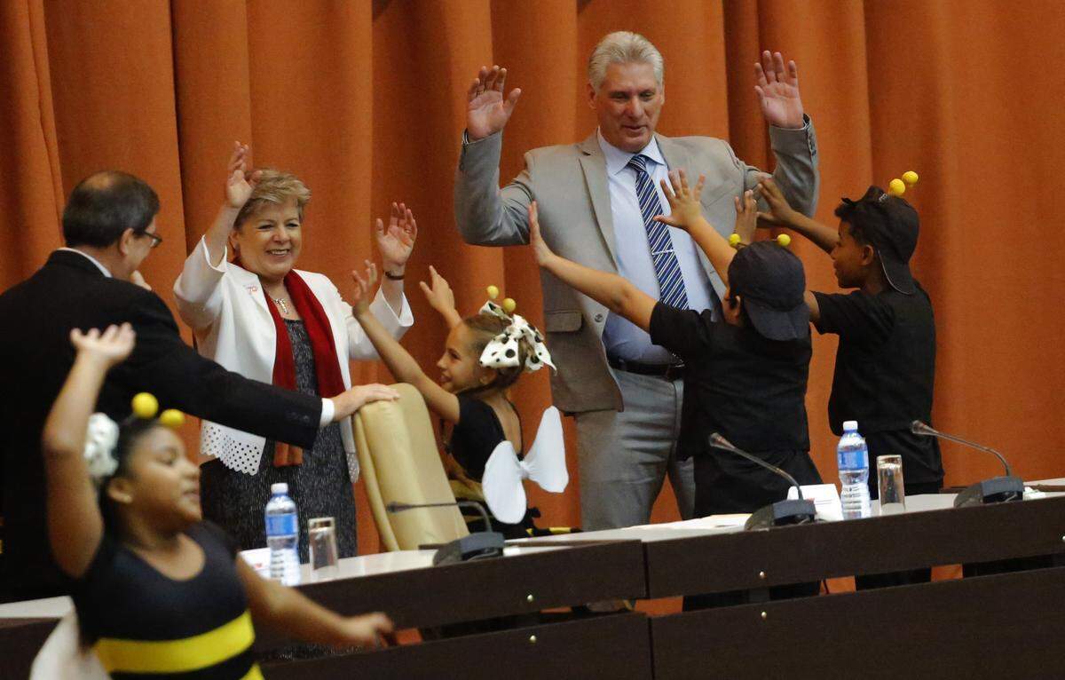 Cuba's President Miguel Diaz-Canel dances with children from a theater group during the opening session of the Economic Commission for Latin America and the Caribbean meeting in Havana.