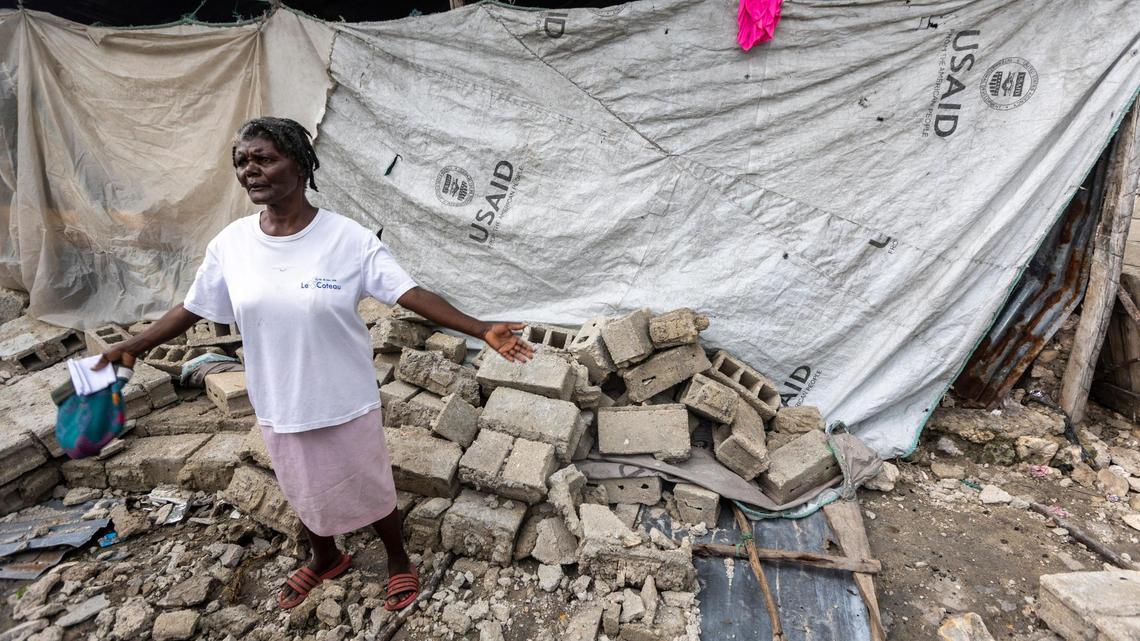 Mertilia Zamor, who lives in Boucan Noël, was loaned a five-year-old U.S. Agency for International Development tarp, which was given out during Hurricane Matthew, to cover her damaged house after the 7.2 magnitude earthquake rocked this fishing village in the western reaches of southern Haiti on Aug. 14, 2021.
