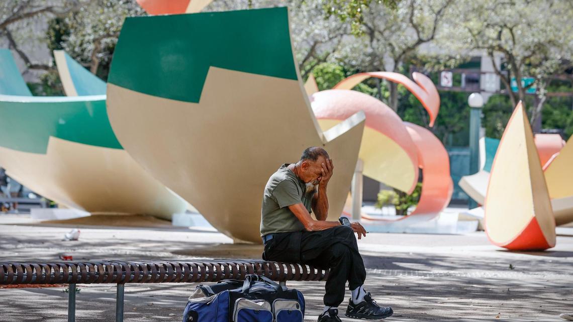 Robert Carlos, 68, who says he is homeless, sits on a bench as Marion McFadden, a deputy assistant secretary for the U.S. Department of Housing and Urban Development Department, speaks of financial assistance being provided to help people experiencing homelessness, on Thursday, Feb. 2, 2023.