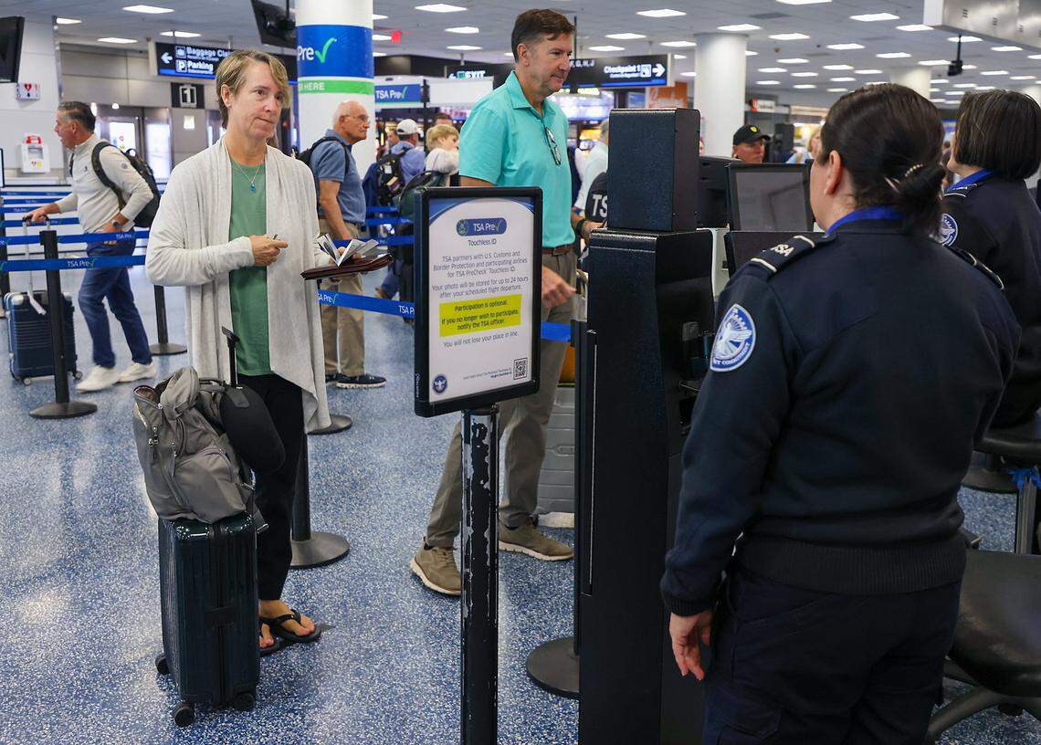 A traveler holds travel documents in hand (not needed) as she is processed through the Toucheless ID security checkpoint as Miami International Airport, along with American Airlines and the Transportation Security Administration, hosted a press conference to discuss the availability of TSA PreCheck® Touchless ID at MIA Door 1 in Departures on Tuesday, February 10, 2026, in Miami, Florida.