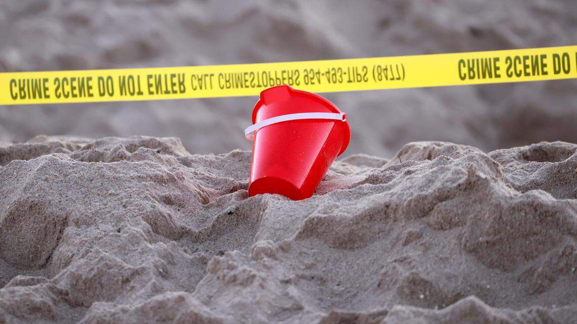Yellow crime scene tape marks the area in a Lauderdale-by-the-Sea beach where a 7-year-old girl died on Tuesday, Feb. 20, 2024, after sand buried her at the bottom of a deep hole she and her brother had dug out on the beach, authorities said. Her brother is hospitalized.