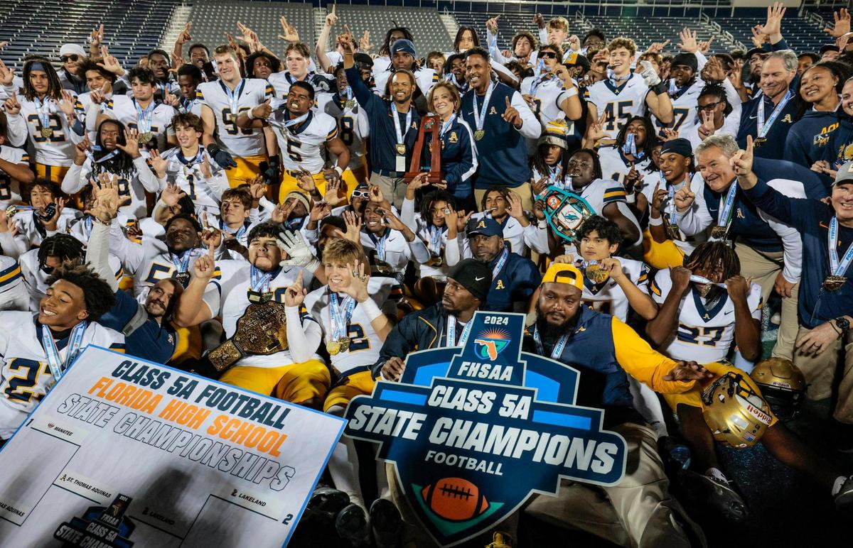 St. Thomas Aquinas players and coaches clebrate the championship win over Lakeland Dreadnaughts in the Florida High School Football State Championships - Class 5A game at Pitbull Stadium on the campus of Florida International University in Miami, Florida, on Thursday, December 12, 2024.