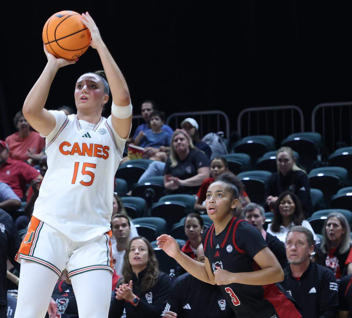 UM guard Vittoria Blasigh, left, takes the jump shot during the first half as University of Miami Women's basketball played in the ACC opener against North Carolina State at the Watsco Center in Coral Gables, Florida, on Sunday, December 14, 2025.