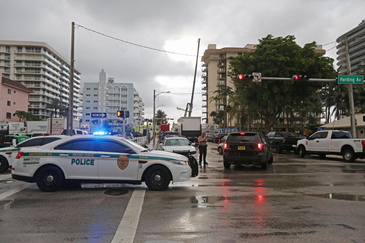 Cranes work in the distance on the collapsed Champlain Towers South Condo at 8777 Collins Ave in Surfside June 28, 2021 after a rain shower early Monday morning.