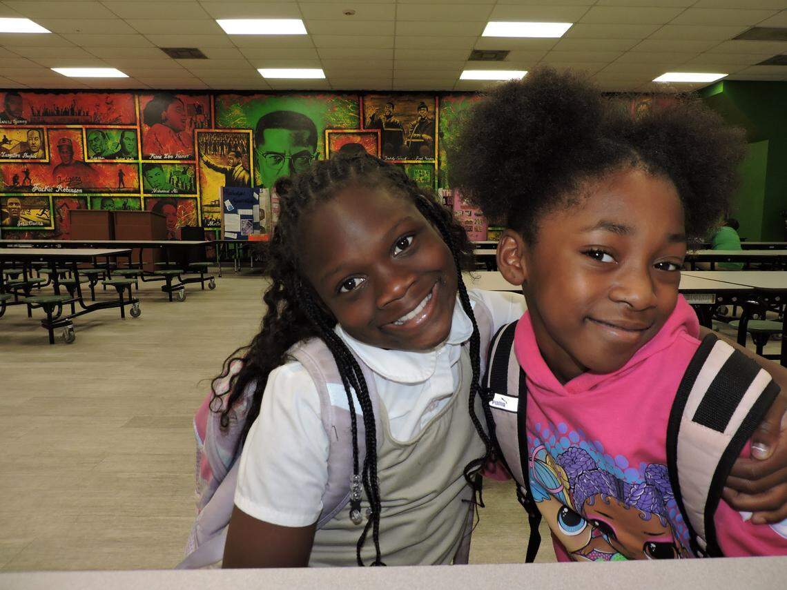 Natalie Mincey, left, and Ke’Ari Thornton have some fun in the school cafeteria at Beacon College Preparatory in Opa-locka before the start of their Girls Inc. after-school program at the school on Nov. 4, 2022.