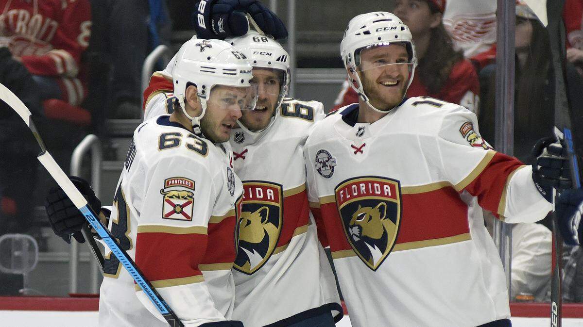 Florida Panthers’ Mike Hoffman (68), center, is congratulated by right wing Evgenii Dadonov (63) of Russia and left wing Jonathan Huberdeau (11) after scoring a goal against the Detroit Red Wings during the first period of an NHL hockey game in Detroit, Saturday, Dec. 22, 2018. (AP Photo/Jose Juarez)