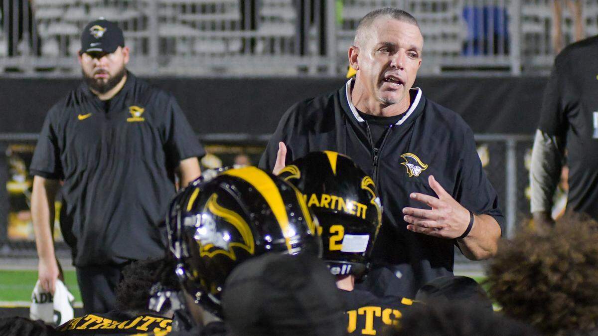 American Heritage coach Mike Smith speaks to his team after losing to Tampa Berkeley Prep in a Class 2M state semifinal on Friday, Dec. 1, 2023, at American Heritage School in Plantation, Florida.