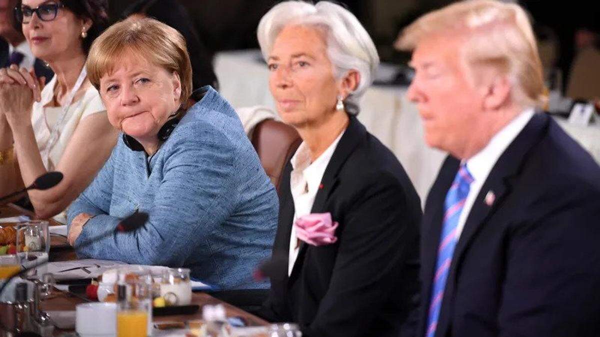 German Chancellor Angel Merkel grimaces in President Trump’s direction at the 2018 G7 Summit in Quebec.
