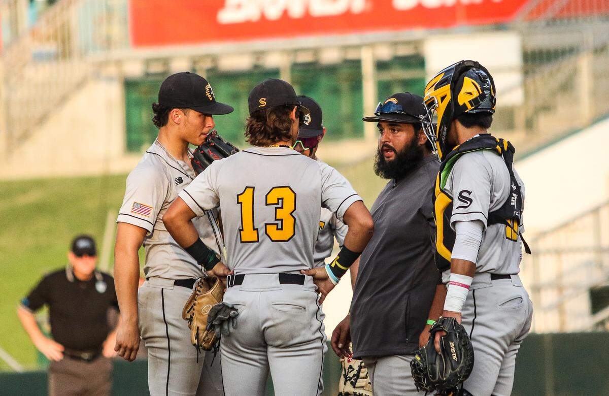 Miami Sunset coach Julio Mendoza meets with his players at the mound during Friday’s Class 4A state semifinal against Citra North Marion at Hammond Stadium in Fort Myers. The Knights lost 5-4.