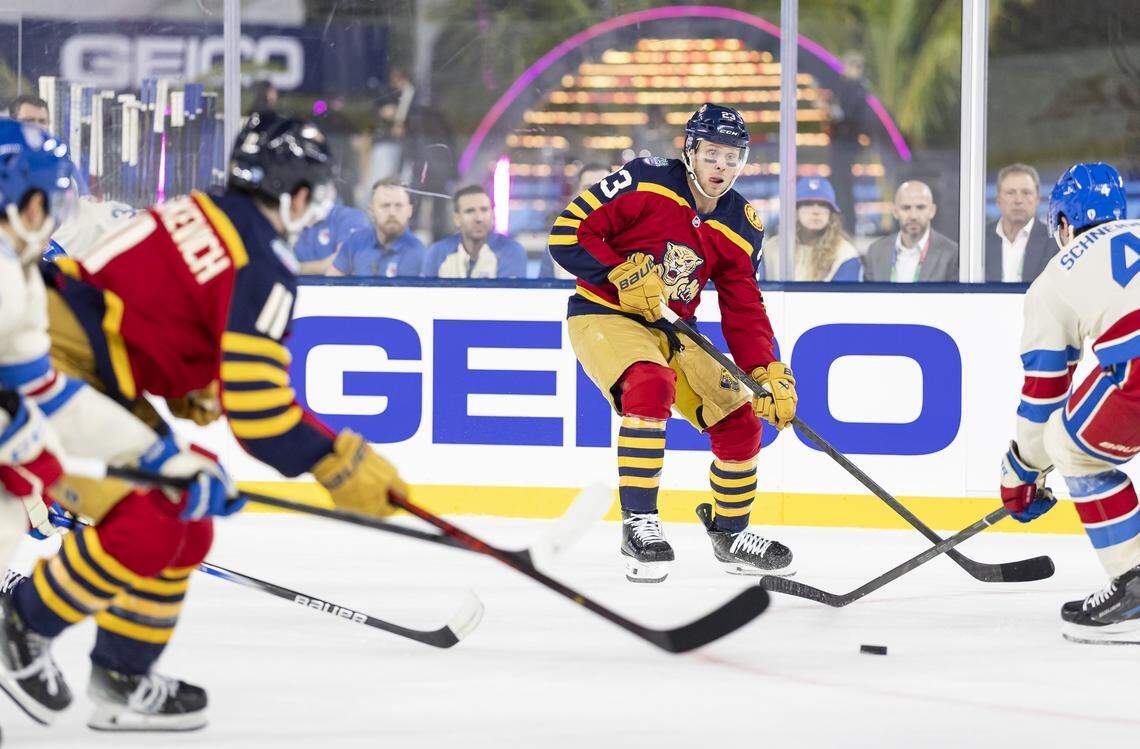 Florida Panthers center Carter Verhaeghe (23) looks to pass as New York Rangers defenseman Braden Schneider (4) defends in the first period of their Winter Classic outdoor hockey game at loanDepot park on Friday, Jan. 2, 2026, in Miami, Fla.