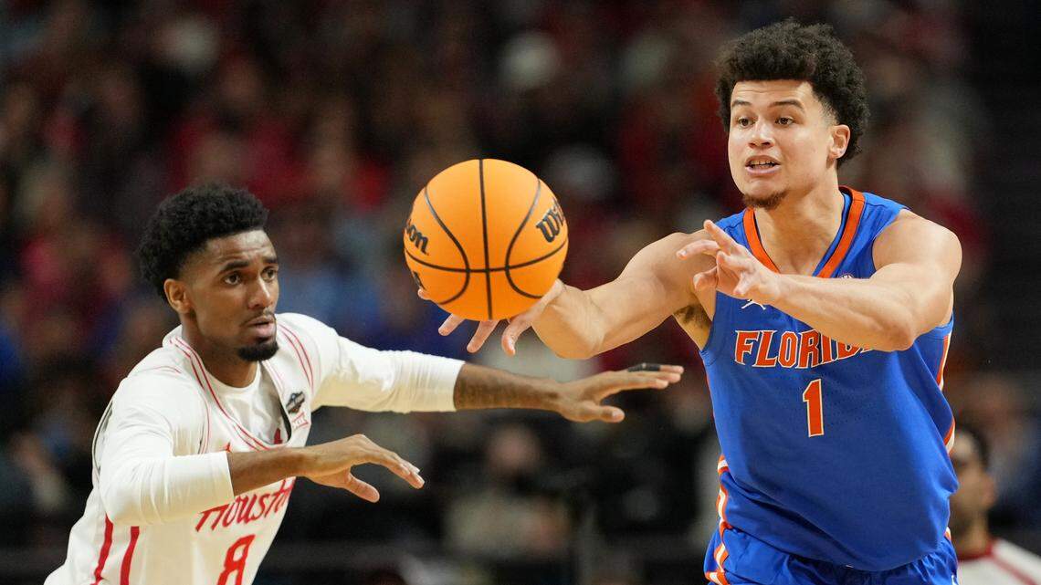 Florida Gators guard Walter Clayton Jr. (1) passes the ball against Houston Cougars guard Mylik Wilson (8) during the first half of the national championship game of the Final Four of the 2025 NCAA Tournament at the Alamodome.