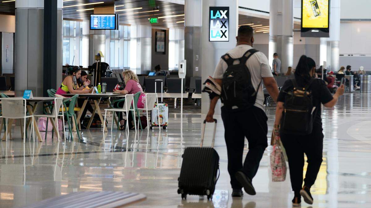 Passengers wait for their flights at the Los Angeles International Airport on May 24, 2021. The Biden administration is ending the COVID-19 testing requirement for travelers entering the U.S. from international locations on June 12, an official said.