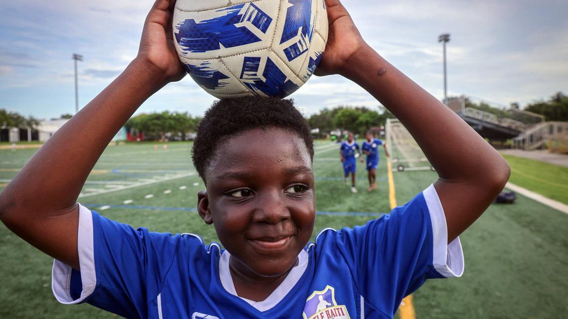 Nozel Jean Kenson, center, retrieves the ball as practice ends at the Little Haiti FC at Little Haiti Soccer Park in Miami.