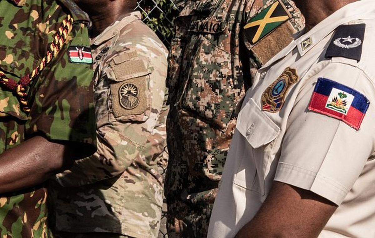 Kenyan police officers arrive at Toussaint Louverture International Airport in Port-au-Prince, Haiti, on December 8, 2025. Kenya announced on December 8th that it had deployed more than 230 highly specialized police officers. They arrive at a critical moment, following the expansion of the Gang Suppression Force's (GSF) mandate published on October 3, 2025. (Photo by Clarens SIFFROY / AFP via Getty Images)