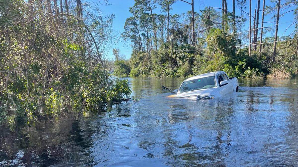 A car is submerged in flood water in North Port, Florida, after Hurricane Ian in September.