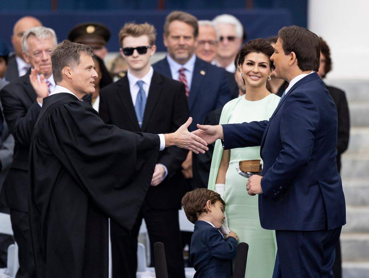 Florida Supreme Court Justice Carlos G. Muñiz swears in Florida Gov. Ron DeSantis, who is accompanied by his wife, Casey DeSantis, during his inauguration ceremony on Tuesday, January 3, 2023, in Tallahassee, Fla.