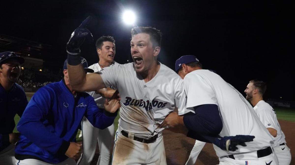 Troy Johnston celebrates with teammates after hitting a walk-off single for the Pensacola Blue Wahoos on Friday, June 3, 2022.
