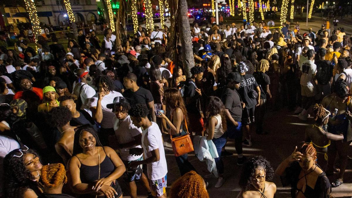 Crowds fill the beach walk along Ocean Drive during spring break in Miami Beach, Florida, on Saturday, March 19, 2022.