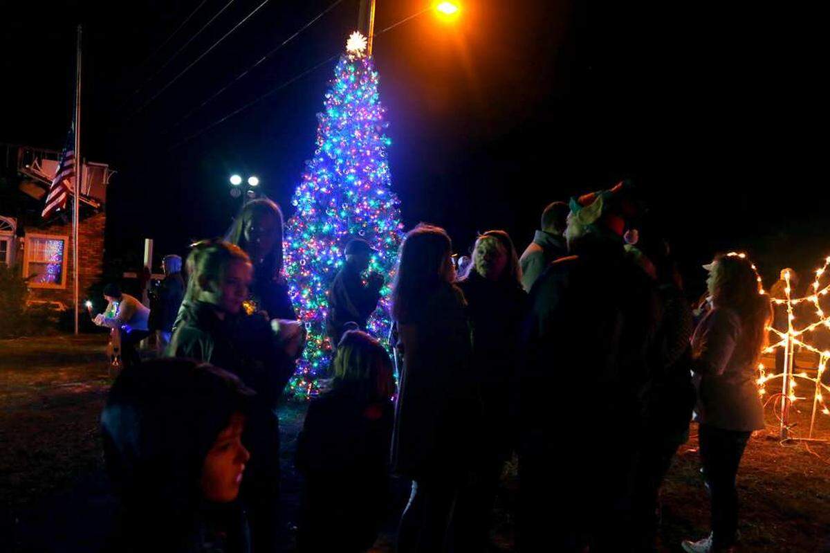 Residents of Mexico Beach visit during the annual Christmas tree lighting festival hosted on the lawn in front of Mango Marley’s restaurant and the Parker Realty building on U.S. 98 in Mexico Beach.